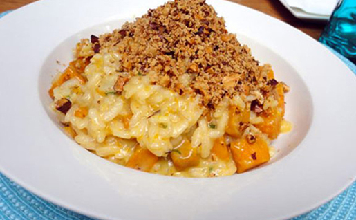  risoto de abóbora com queijo canastra e uma camada de farofa de amêndoas e avelãs. 